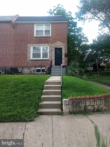 a view of a house with a yard and potted plants