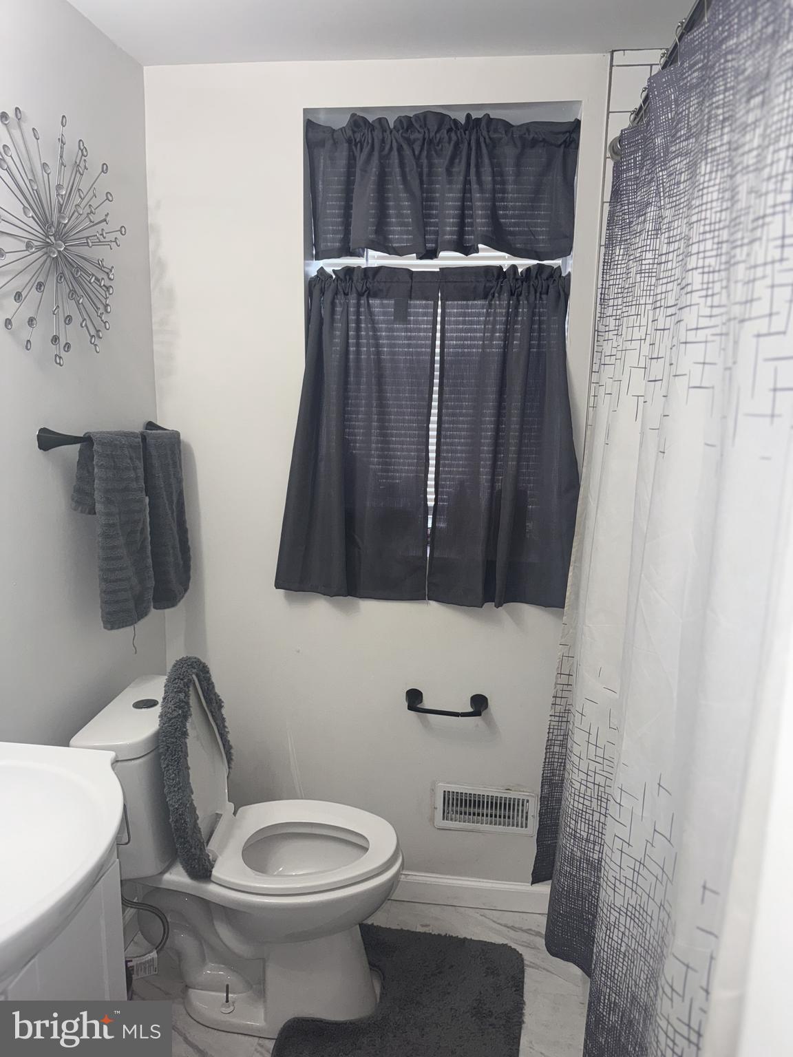 129 Branford Road Darby, PA 19023 - Photo 5 of 10 a bathroom with a toilet and a shower curtain