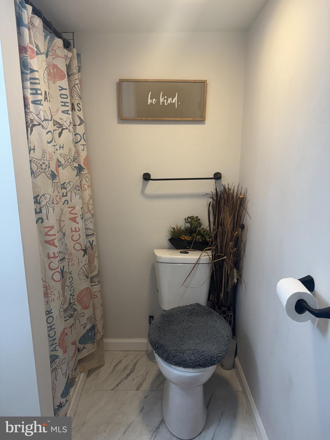 129 Branford Road Darby, PA 19023 - Photo 6 of 10 a white toilet sitting next to a shower curtain
