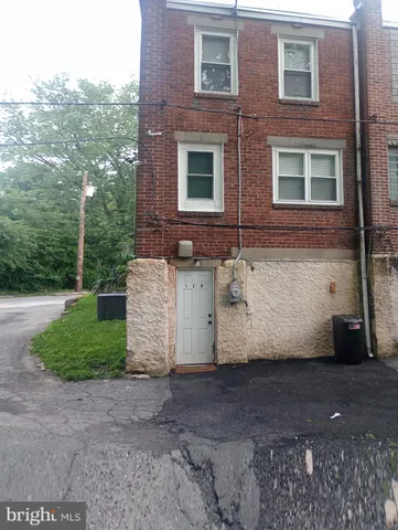 a view of a brick house with a yard