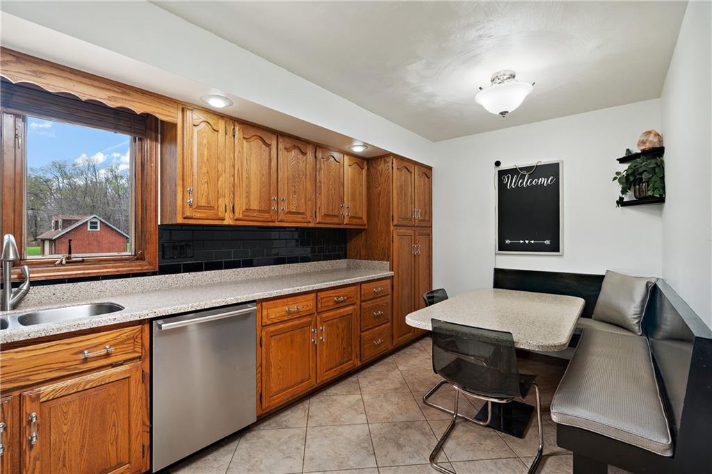 214 Crisswell Road Butler, PA 16002 - Photo 9 of 25 a kitchen with a table chairs sink and cabinets
