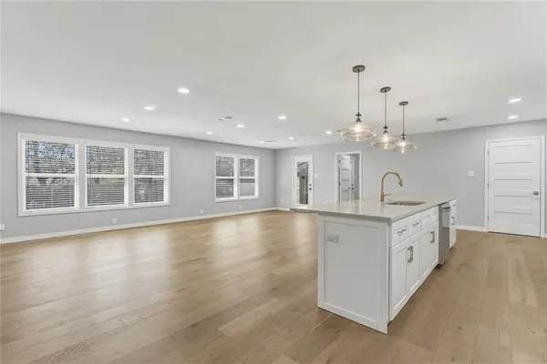 a large white kitchen with a large window