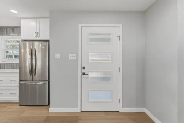 an empty room with a window and ceiling fan
