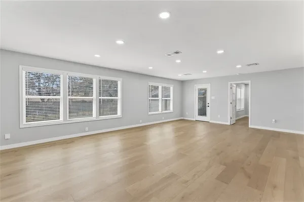 a view of a livingroom with wooden floor and a window