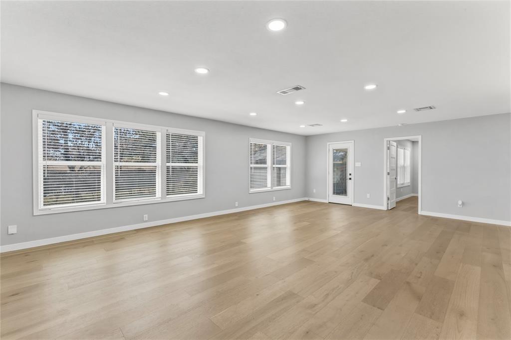 4600 Cedar Mountain Drive Waco, TX 76708 - Photo 19 of 40 a view of an empty room with a window and wooden floor