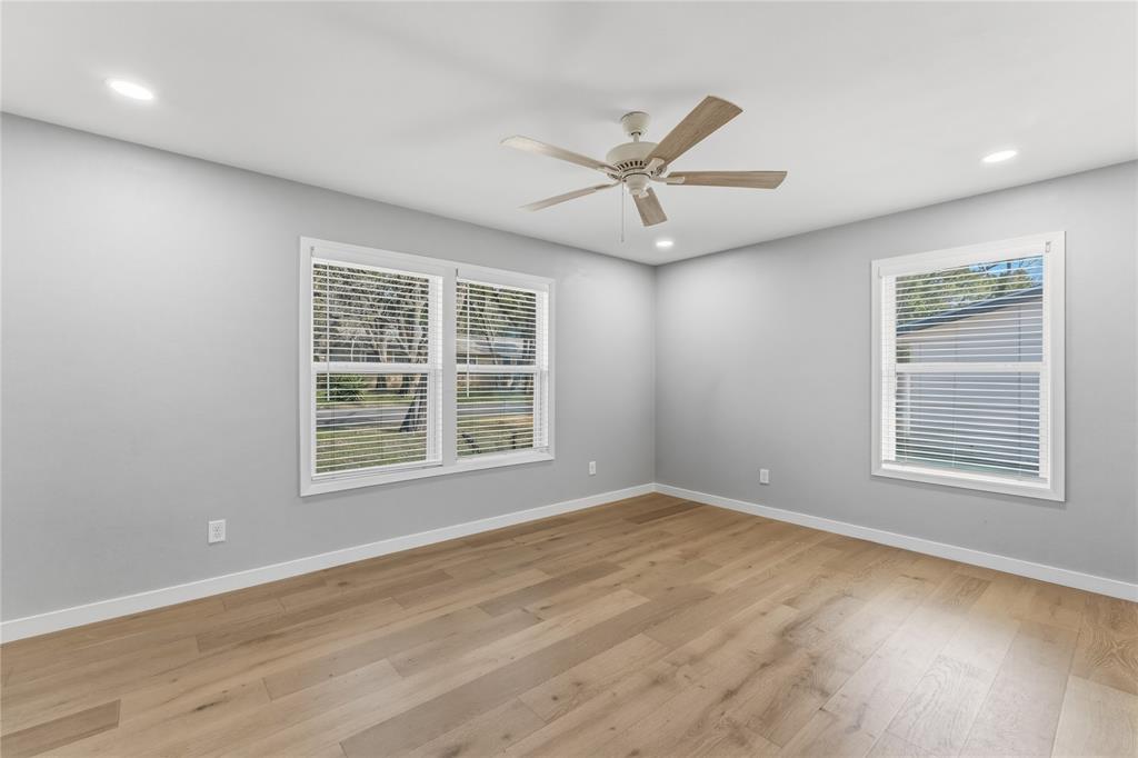 4600 Cedar Mountain Drive Waco, TX 76708 - Photo 22 of 40 a view of an empty room with a window and wooden floor
