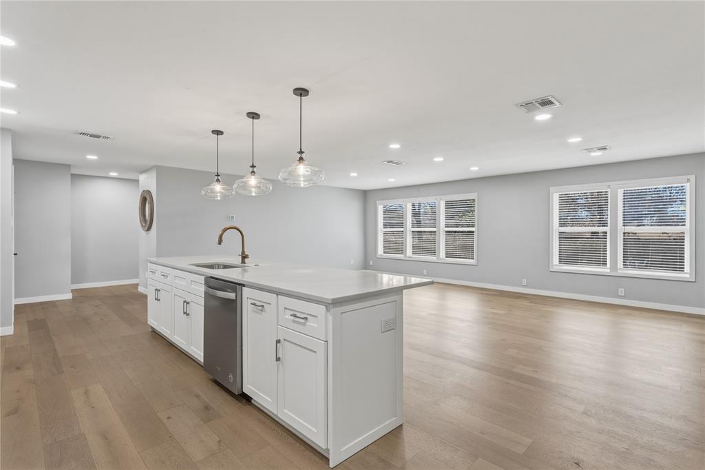 4600 Cedar Mountain Drive Waco, TX 76708 - Photo 6 of 40 a large kitchen with stainless steel appliances kitchen island a large counter top and a wooden floors