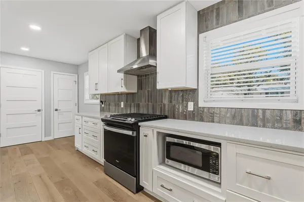 a kitchen with stainless steel appliances granite countertop a stove and a sink