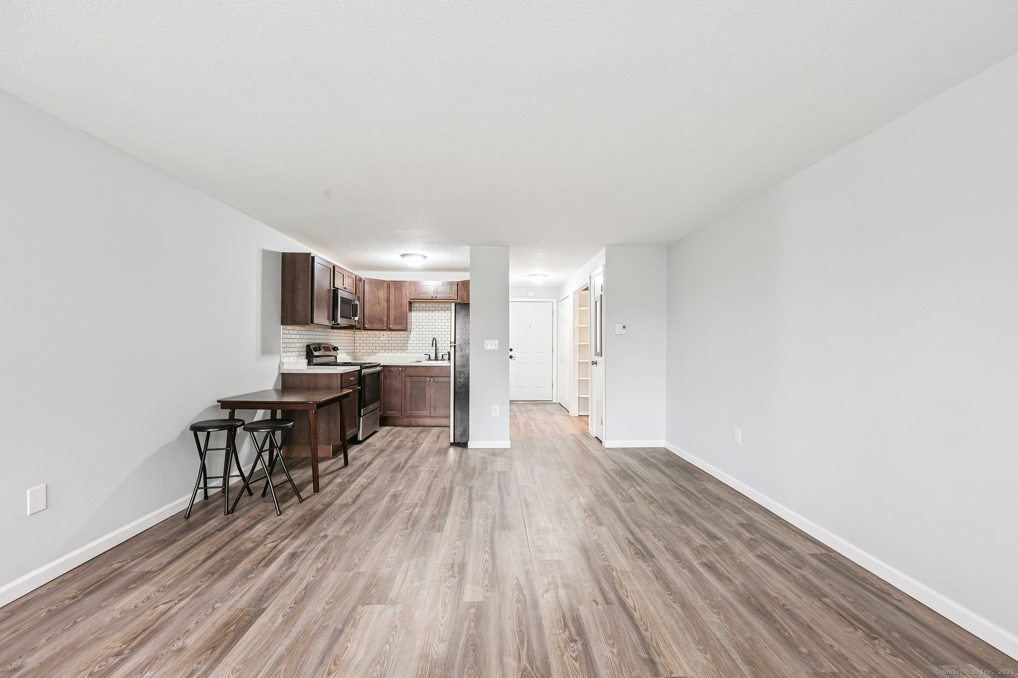 356 Franklin Avenue, Unit A4 Hartford, CT 06114 - Photo 17 of 21 a view of a kitchen with wooden floor and furniture