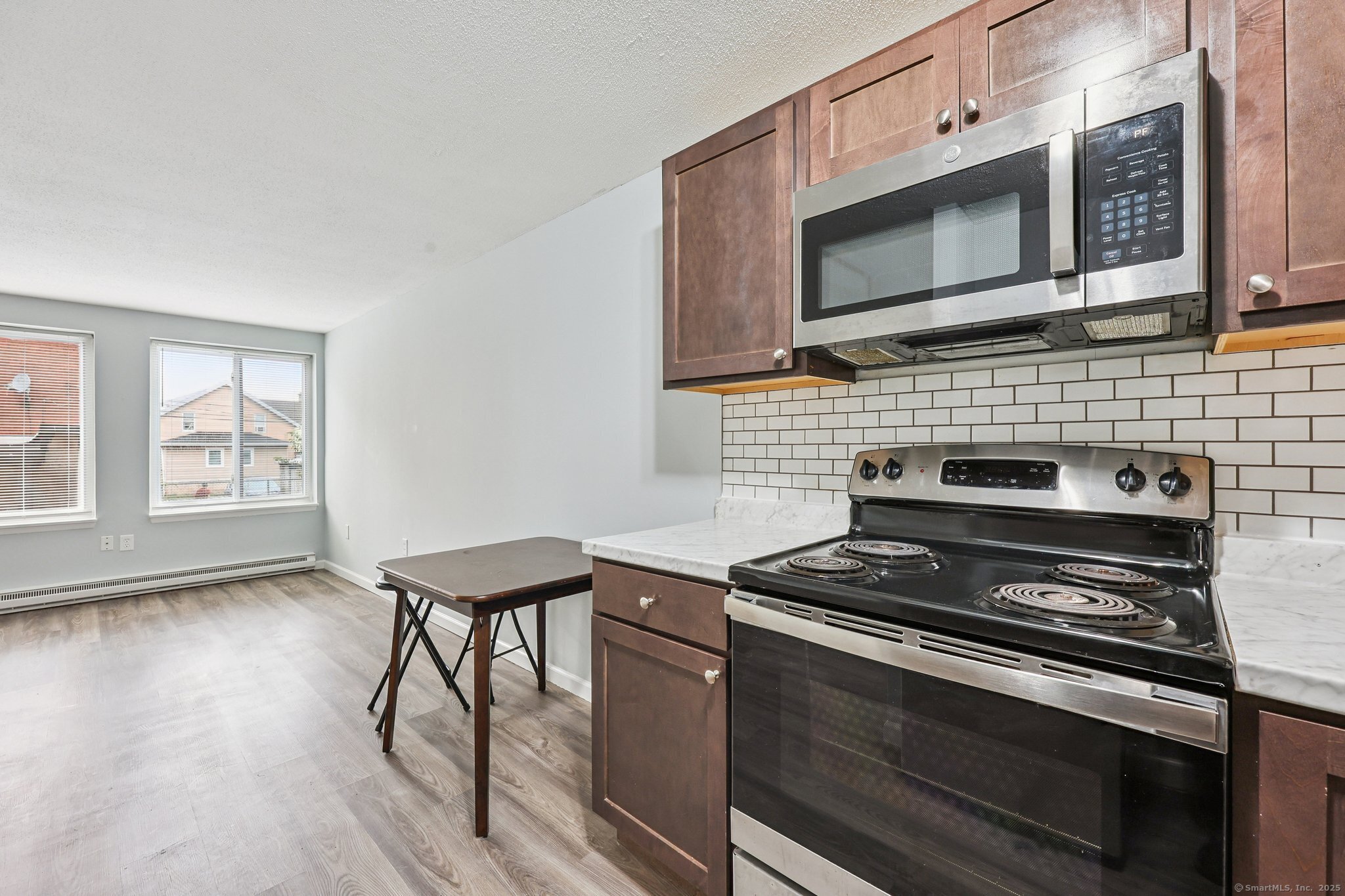 356 Franklin Avenue, Unit A4 Hartford, CT 06114 - Photo 5 of 21 a kitchen with a stove and a microwave