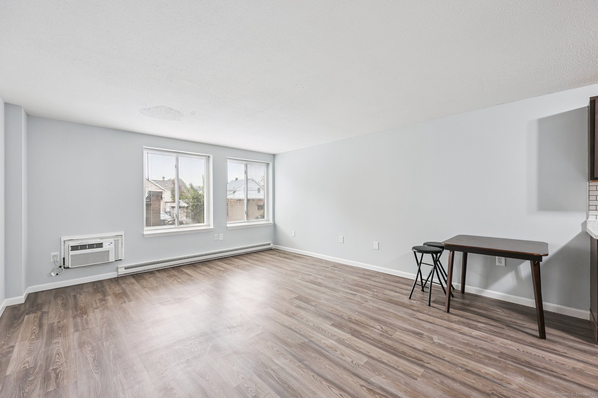 356 Franklin Avenue, Unit A4 Hartford, CT 06114 - Photo 8 of 21 a view of an empty room with wooden floor and a window