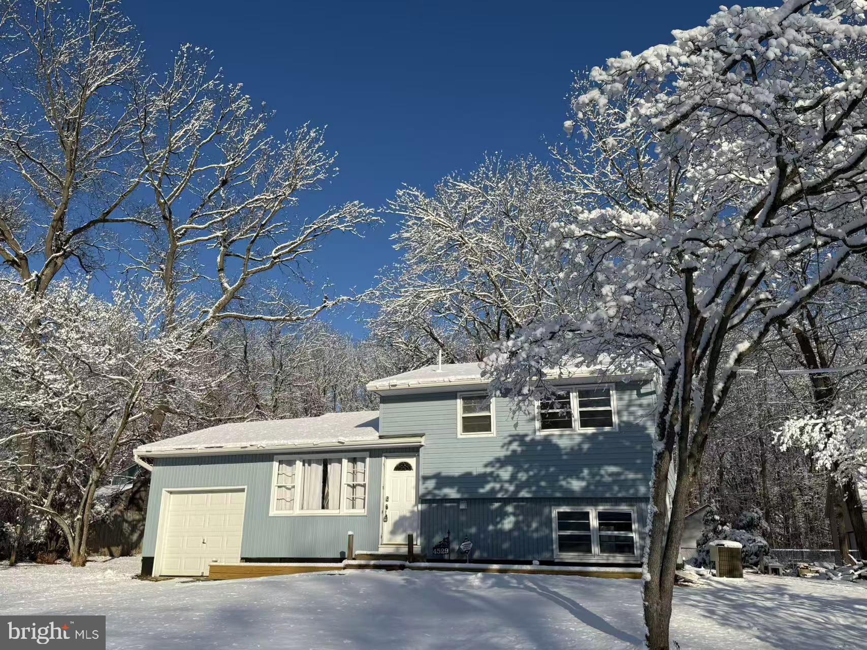 4529 Robin Road Newfield, NJ 08344 - Photo 2 of 39 a front view of a house with a yard and garage