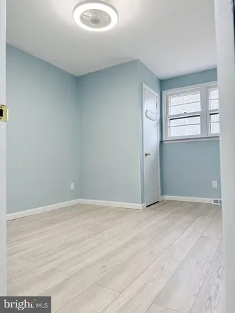 an empty room with windows and entrance