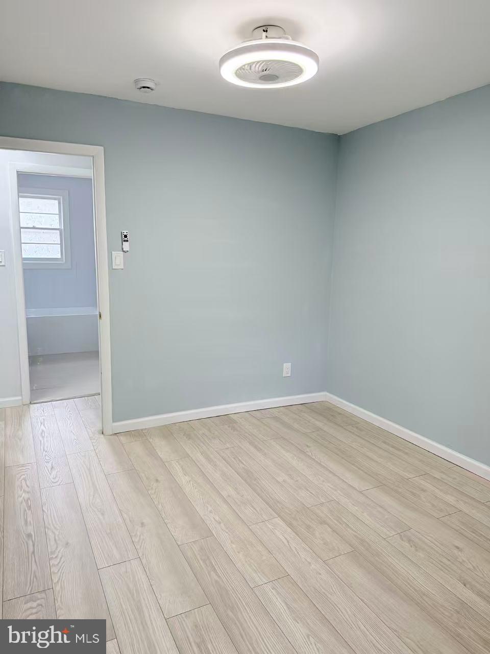 4529 Robin Road Newfield, NJ 08344 - Photo 23 of 39 an empty room with wooden floor and windows