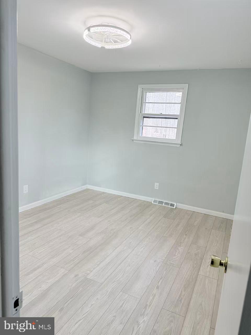 4529 Robin Road Newfield, NJ 08344 - Photo 24 of 39 an empty room with wooden floor and windows