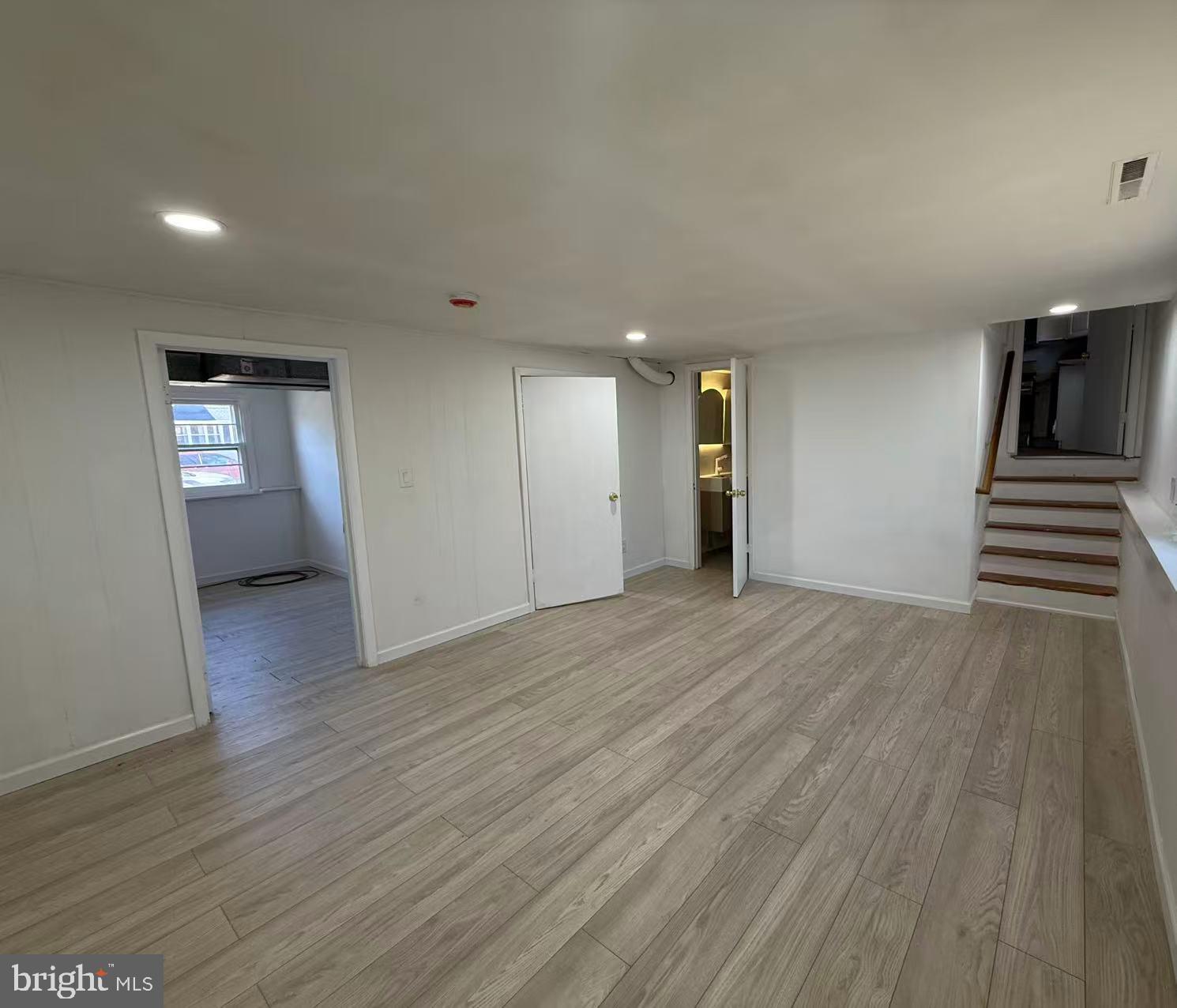4529 Robin Road Newfield, NJ 08344 - Photo 27 of 39 a view of an empty room with wooden floor and a window