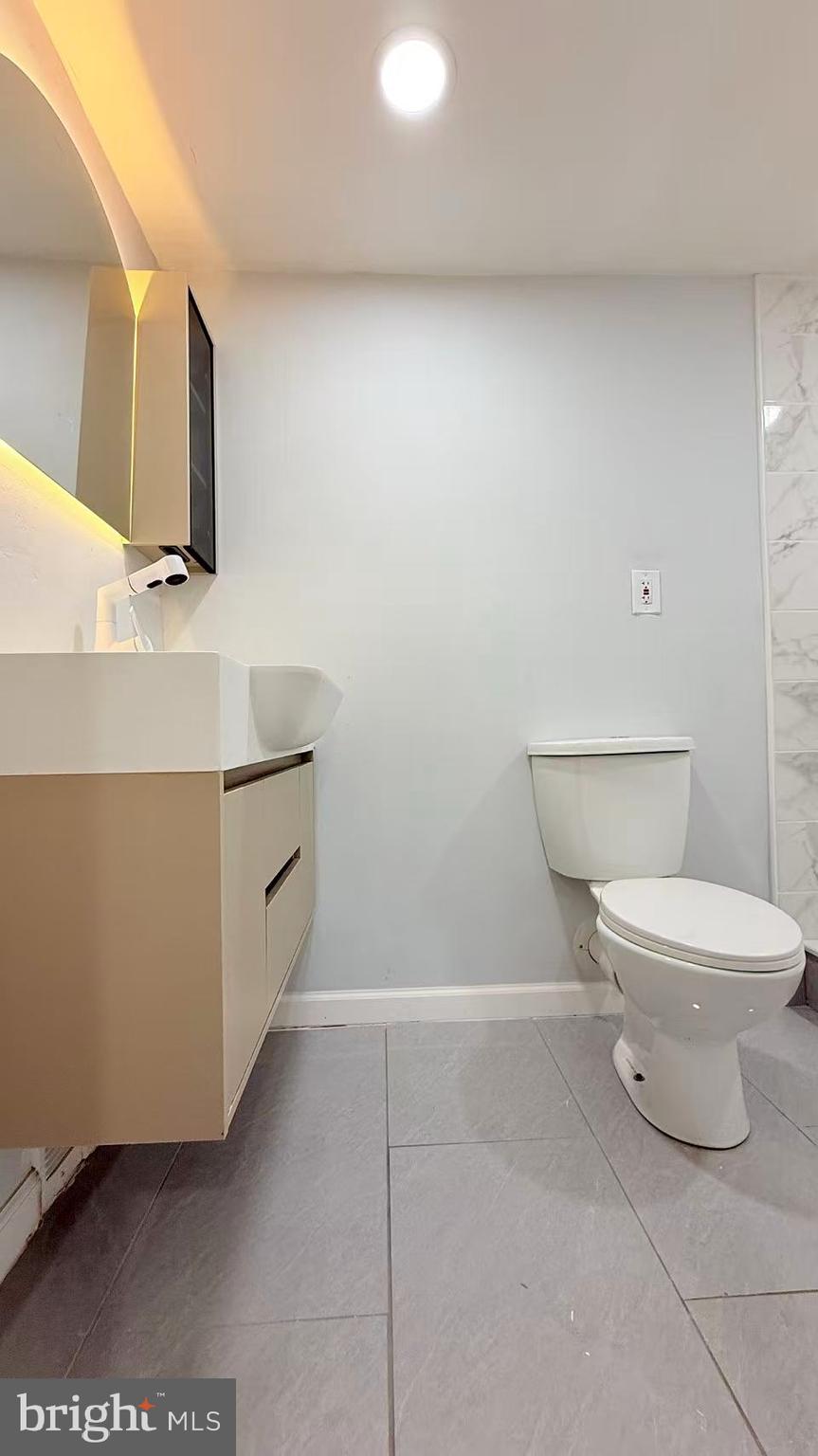 4529 Robin Road Newfield, NJ 08344 - Photo 32 of 39 a bathroom with a toilet a sink and mirror