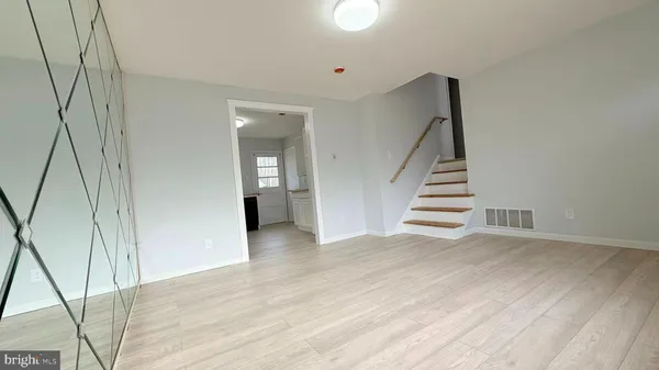 a view of a hallway with wooden floor and entryway