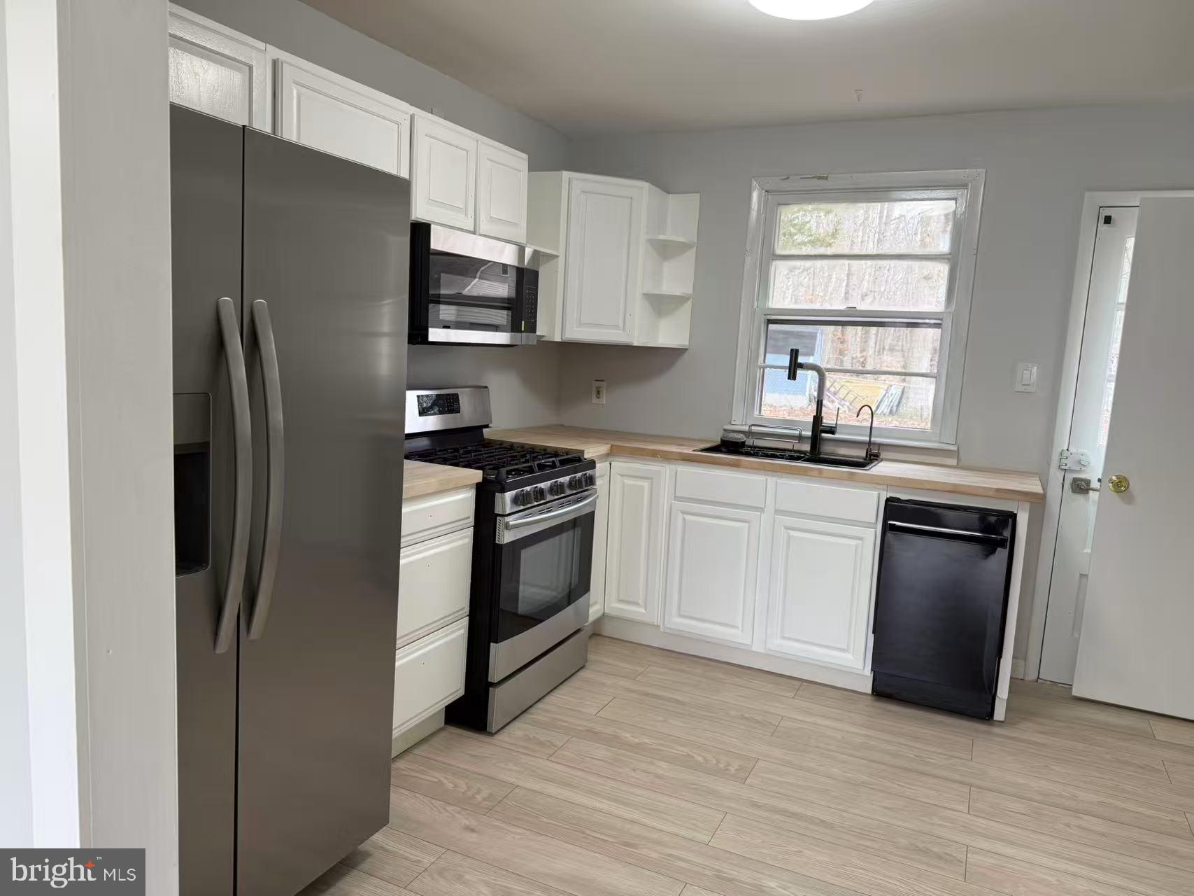 4529 Robin Road Newfield, NJ 08344 - Photo 9 of 39 a kitchen with a refrigerator stove and sink