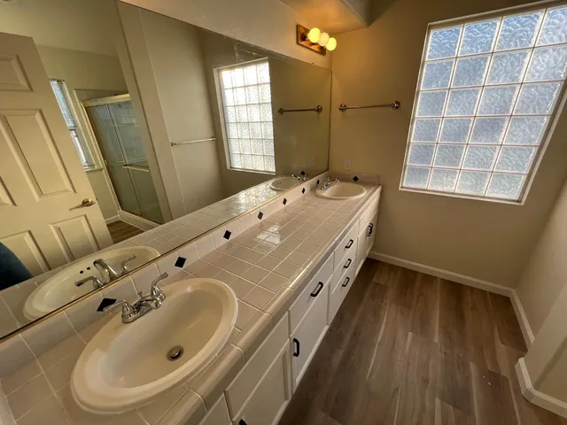 a bathroom with a tub sink and mirror