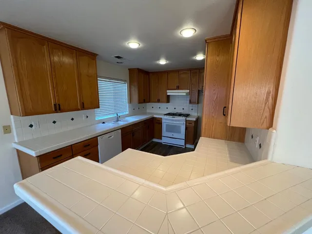 a kitchen with stainless steel appliances sink cabinets and stove top oven