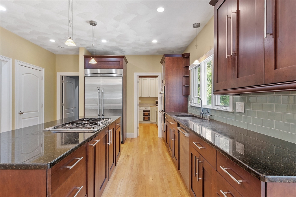 19 Barton Road Harvard, MA 01451 - Photo 8 of 20 a kitchen with stainless steel appliances granite countertop a stove a sink dishwasher and a refrigerator with wooden floor