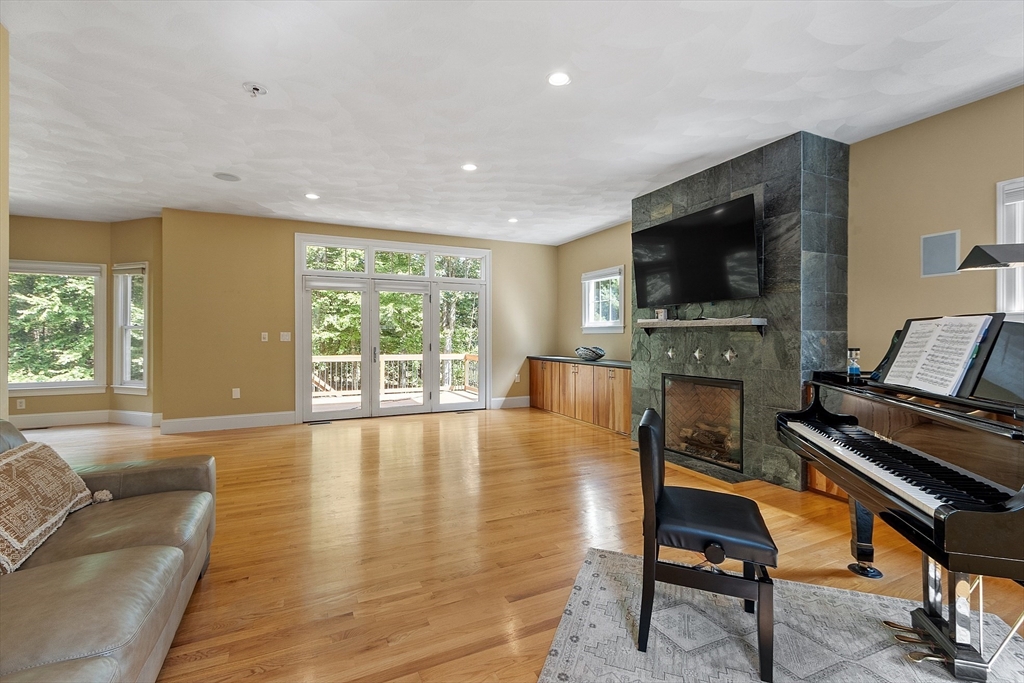 19 Barton Road Harvard, MA 01451 - Photo 10 of 20 a living room with furniture a flat screen tv and a fireplace