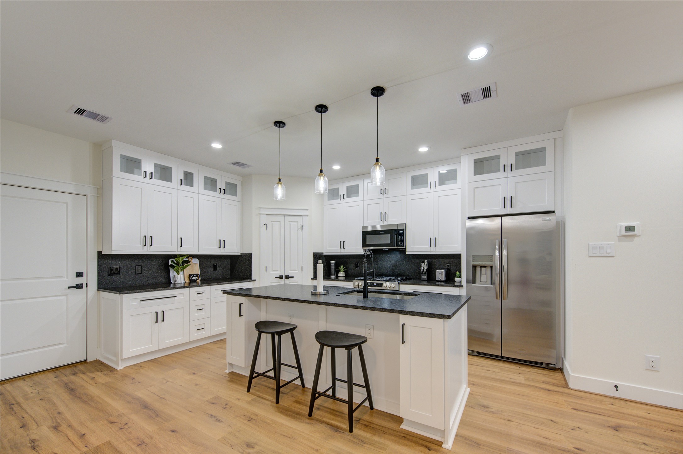 3406 Garapan Street, Unit A Houston, TX 77091 - Photo 14 of 44 a kitchen with stainless steel appliances kitchen island granite countertop a sink and cabinets