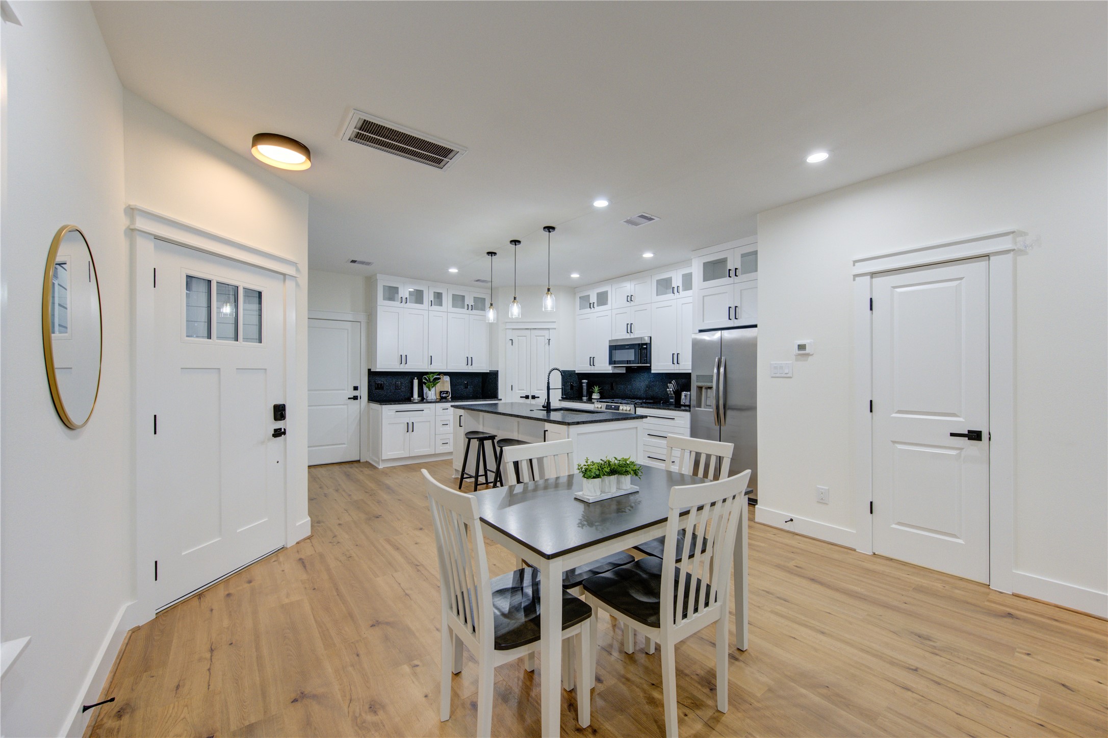 3406 Garapan Street, Unit A Houston, TX 77091 - Photo 15 of 44 a kitchen with stainless steel appliances kitchen island granite countertop a refrigerator and a stove top oven