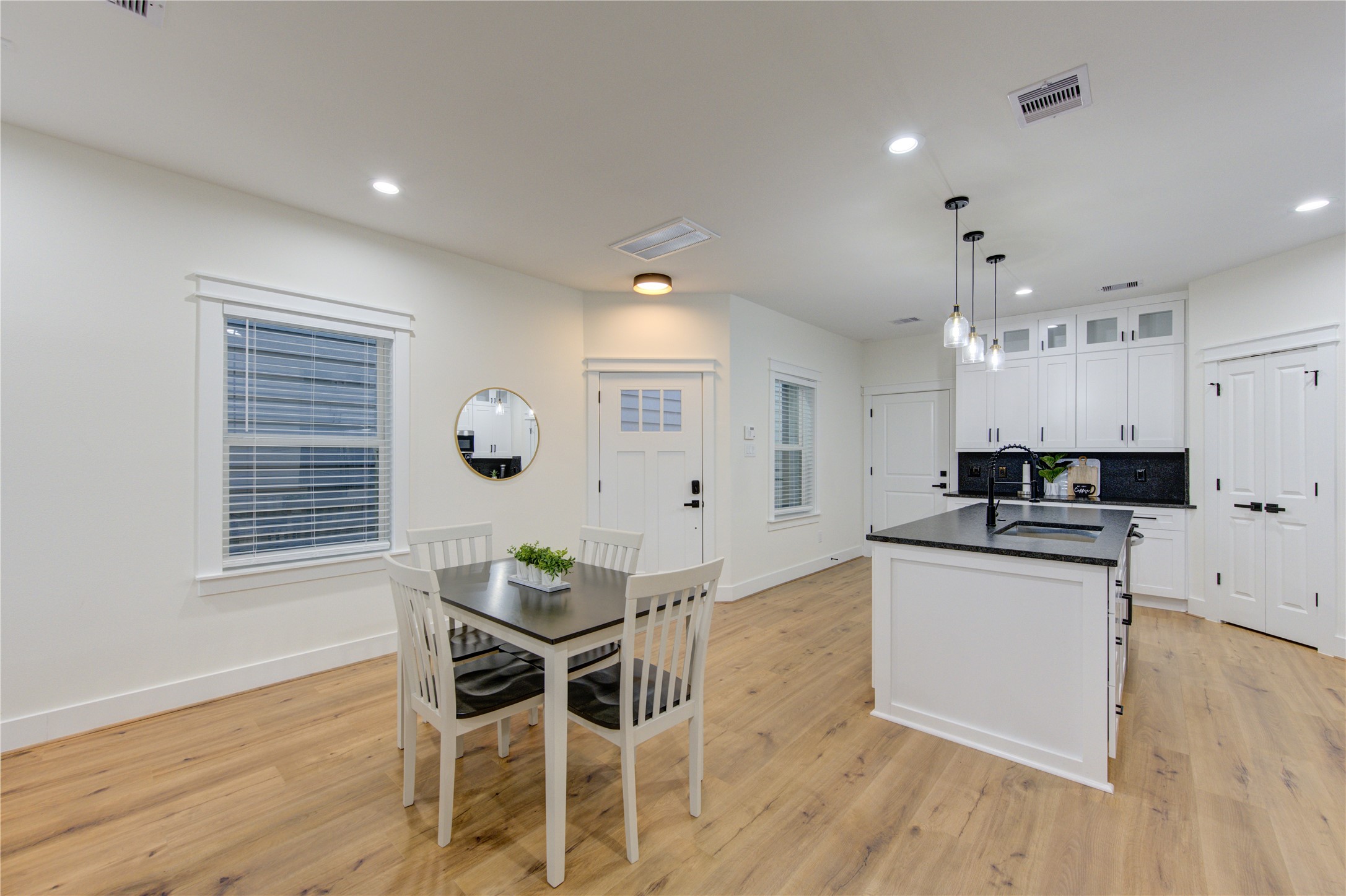 3406 Garapan Street, Unit A Houston, TX 77091 - Photo 16 of 44 a kitchen with stainless steel appliances kitchen island granite countertop a stove a sink and a microwave