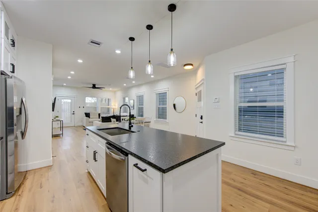 a kitchen with a sink a counter space stainless steel appliances and cabinets