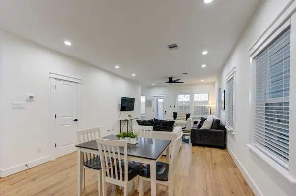 a view of a dining room with furniture window and wooden floor