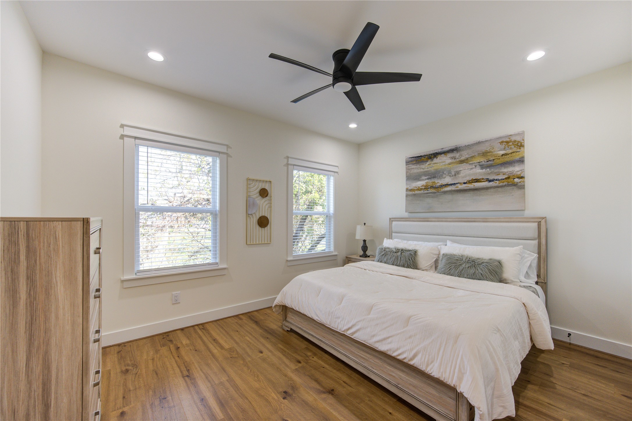 3406 Garapan Street, Unit A Houston, TX 77091 - Photo 28 of 44 a bedroom with a large bed window and wooden floor