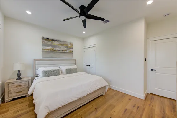 a bedroom with a bed and wooden floor