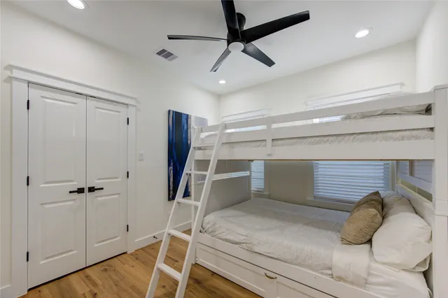 a bedroom with a bed and a ceiling fan