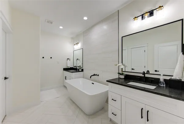a spacious bathroom with sinks and mirror