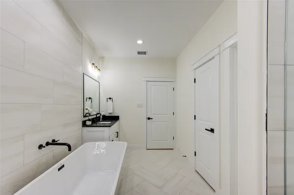 a spacious bathroom with a bathtub and a shower