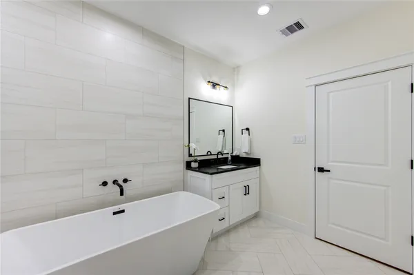a bathroom with a bathtub and a sink