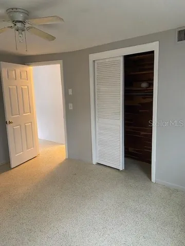 an empty room with closet and cabinet