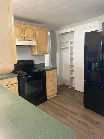 a kitchen with a refrigerator stove and cabinets