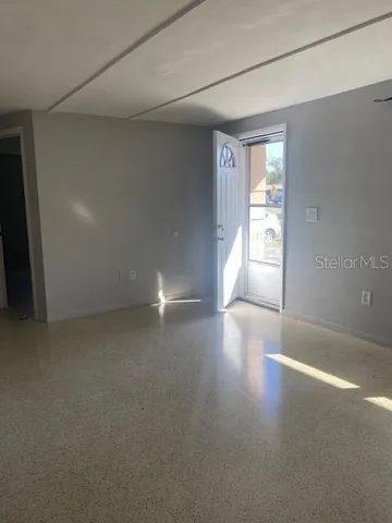 a view of a livingroom with wooden floor and a window