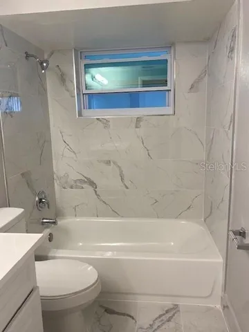 a bathroom with a bathtub and a toilet