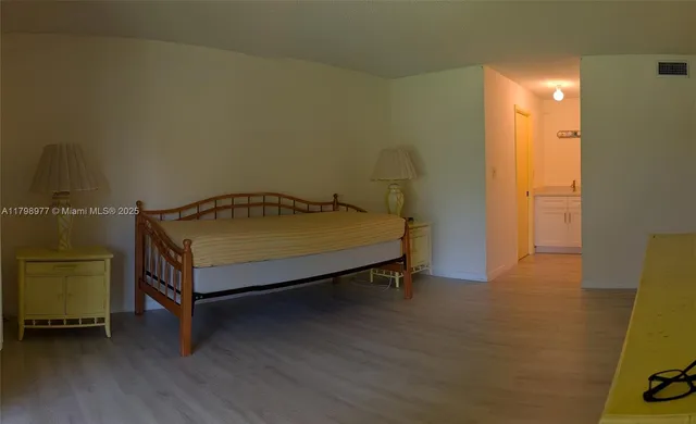 a view of a room with wooden floor and lounge chair