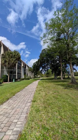 a front view of a house with a yard and trees