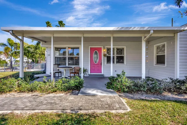 a view of a house with swimming pool and a yard