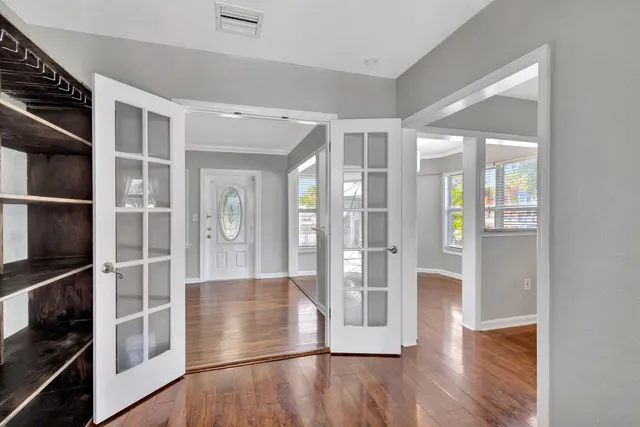 a view of a pathway of a house with wooden fence