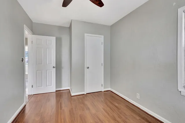 wooden floor in an empty room with a window