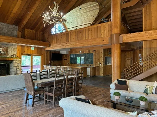 a view of a patio with couches and chairs with wooden floor