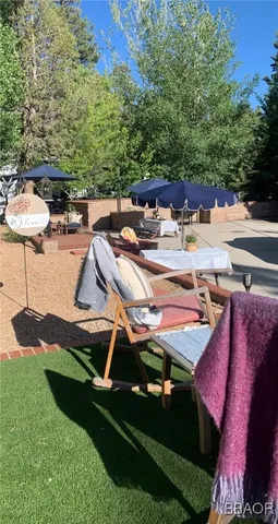 a view of a backyard with sitting area