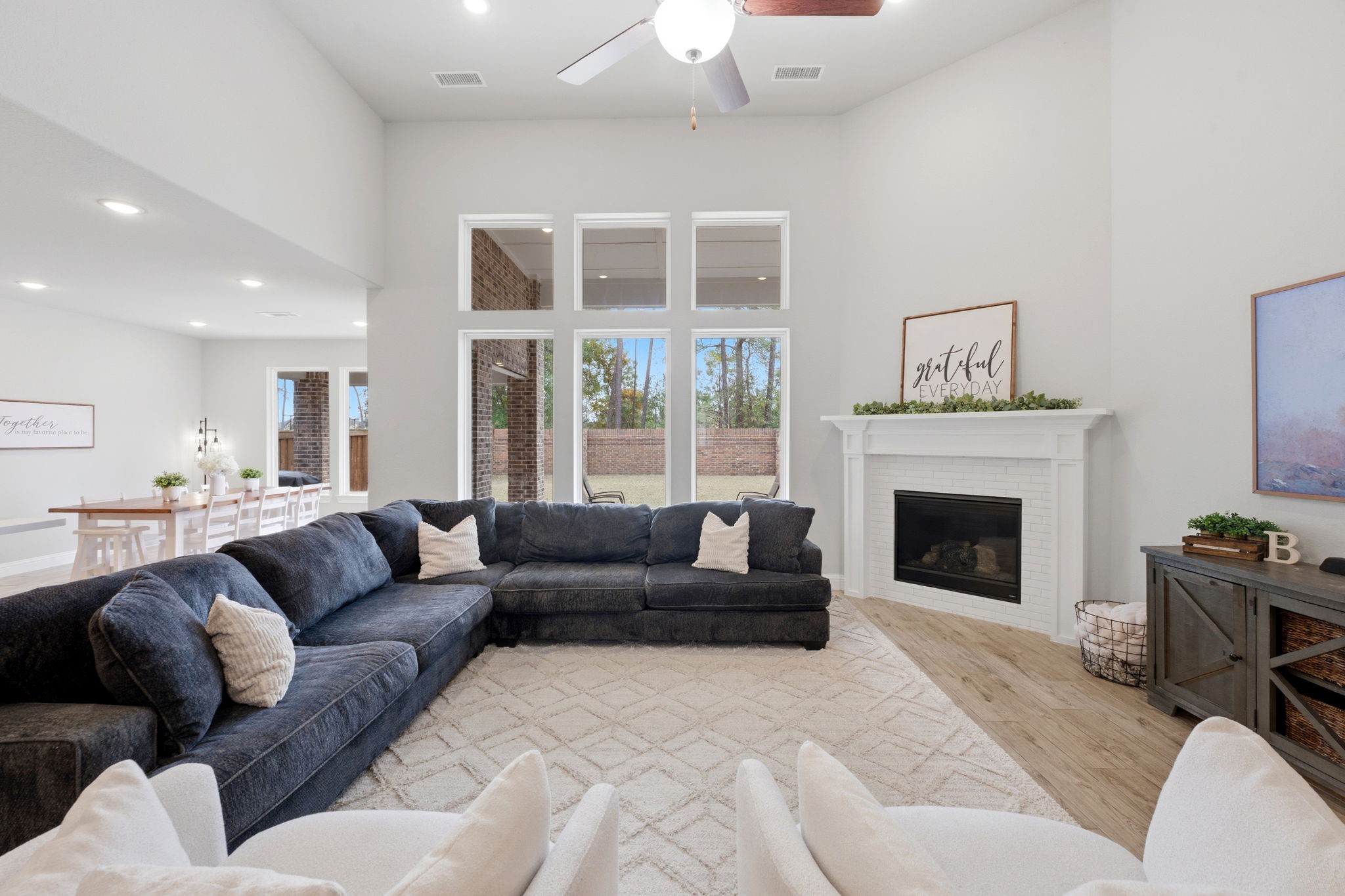 4242 Orchard Pass Drive Spring, TX 77386 - Photo 16 of 50 Grand Living Room Easy for Relaxing or Entertaining with 2 Story Ceiling, Tiled Gas Fireplace, Mantle, Ceiling Fan and Recessed LED Lighting Open to Kitchen and Breakfast Area and Delightful Views to Rear Covered Patio and Yard